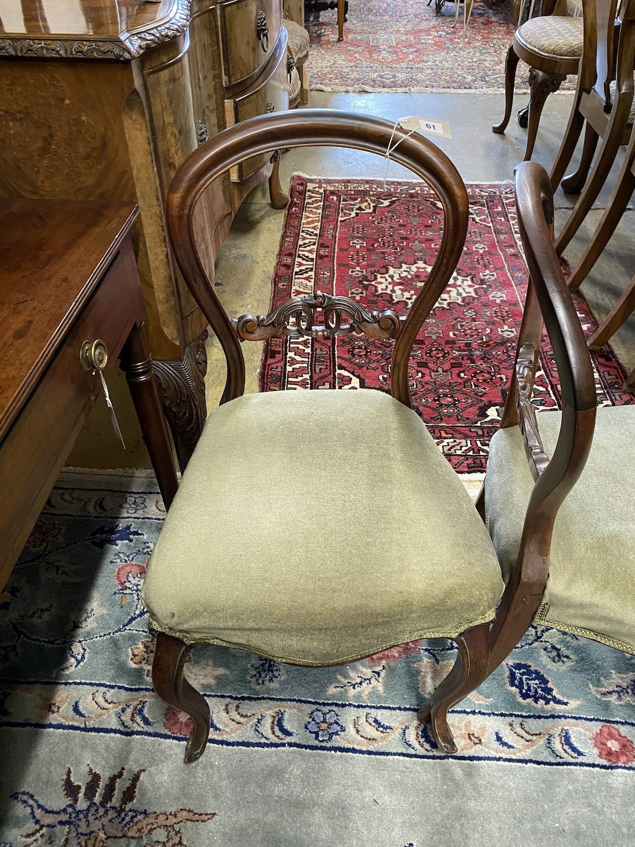 A set of six Victorian rosewood balloon back dining chairs